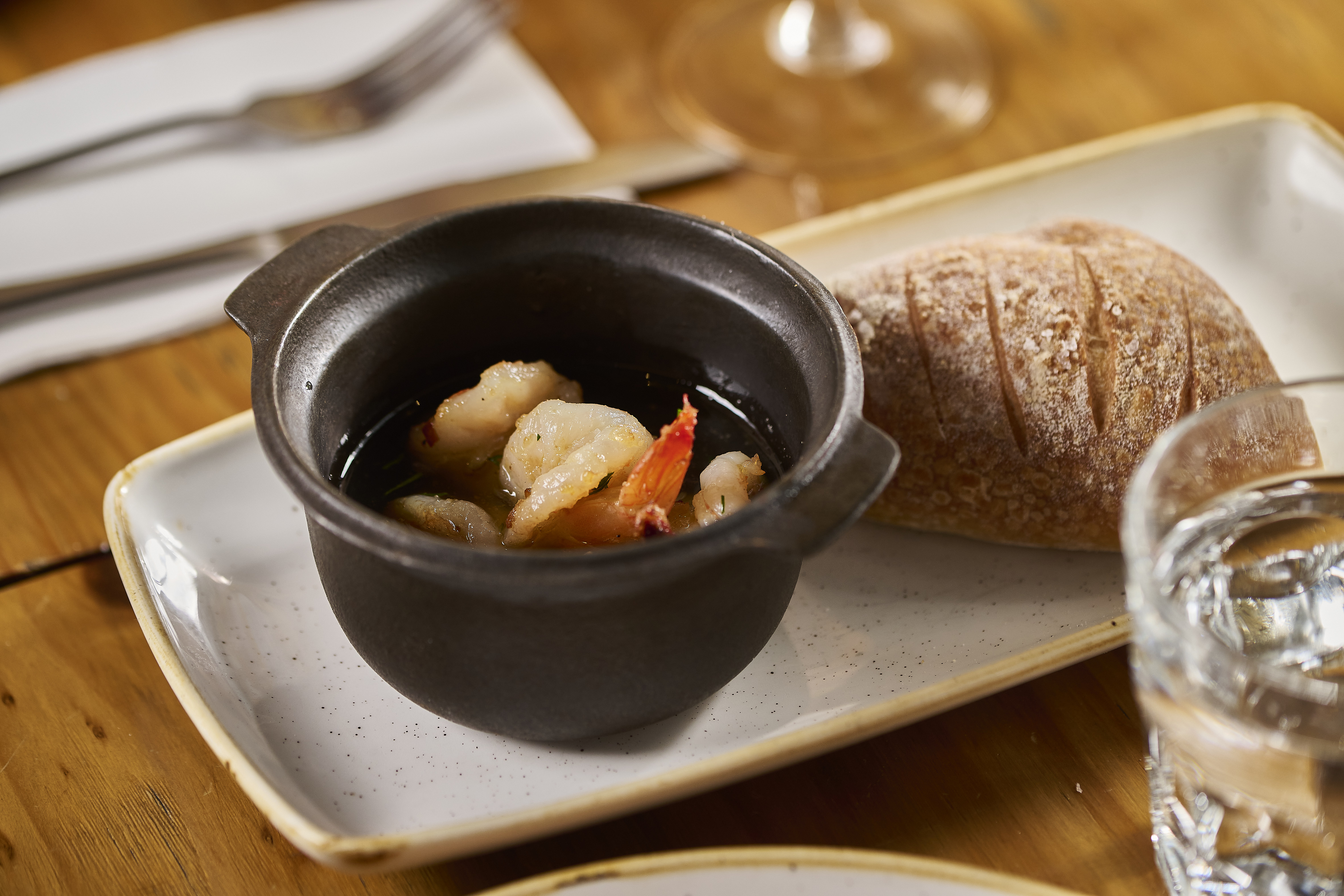 Hot pot sizzling tiger prawns, garlic, chilli, housemade bread.